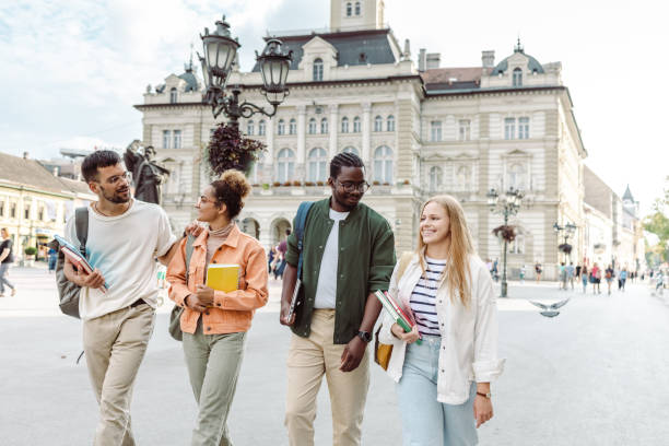 a group of university students cheerfully walking on the street and laughing